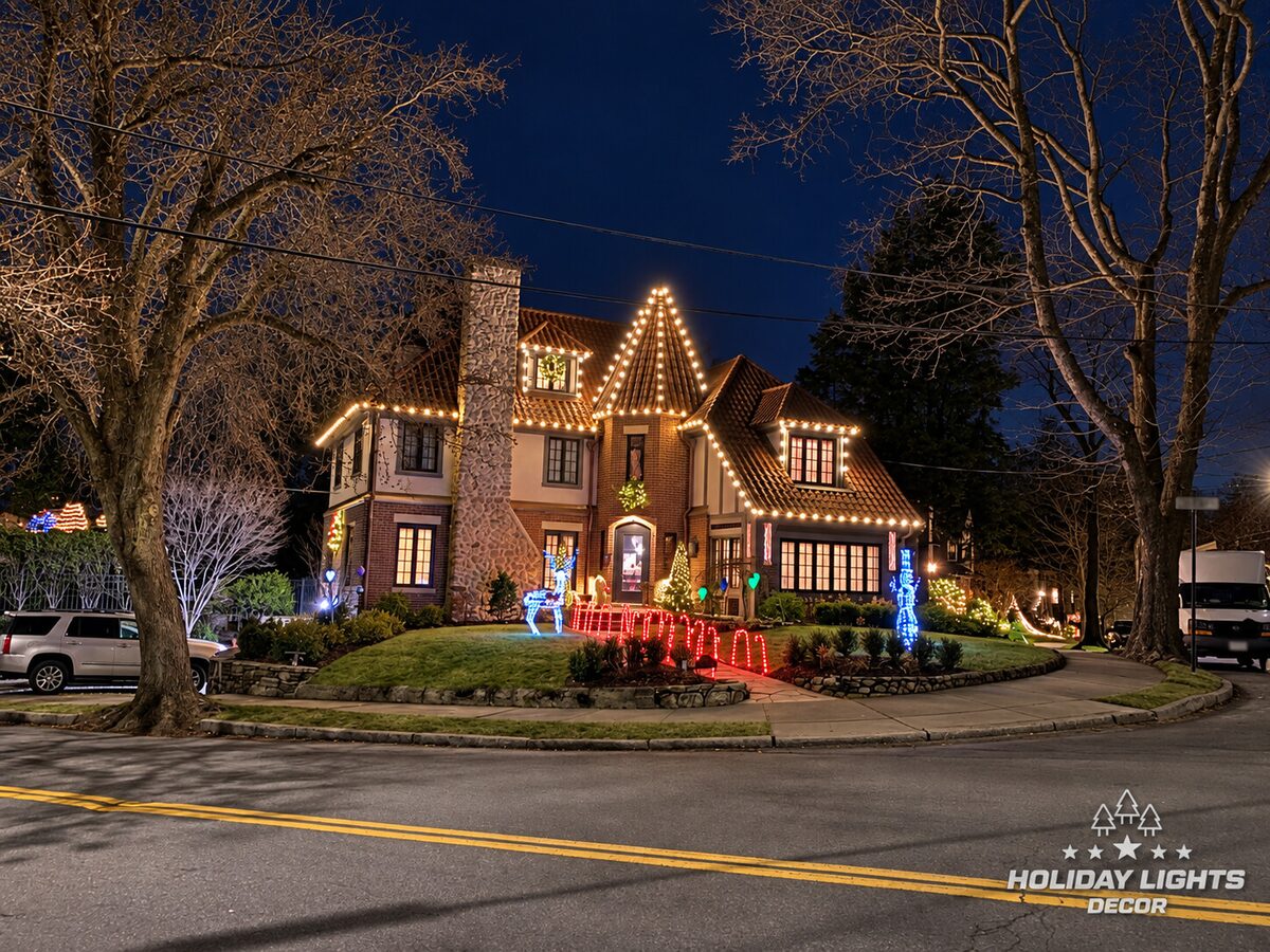 Wide street view showing the complete roofline and illuminated lawn display.