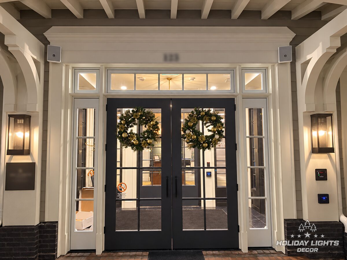 Main glass entrance with matching wreaths on the double doors.