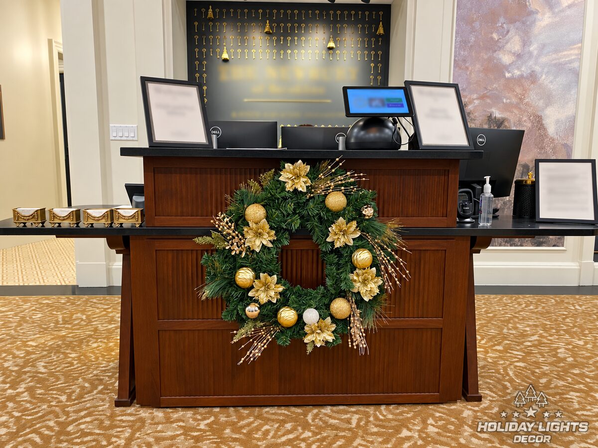 Close view of the reception desk wreath and metallic ornament details.